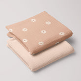 Salmon Poppy muslin swaddle and cream 4-ply muslin baby blanket folded in matching set